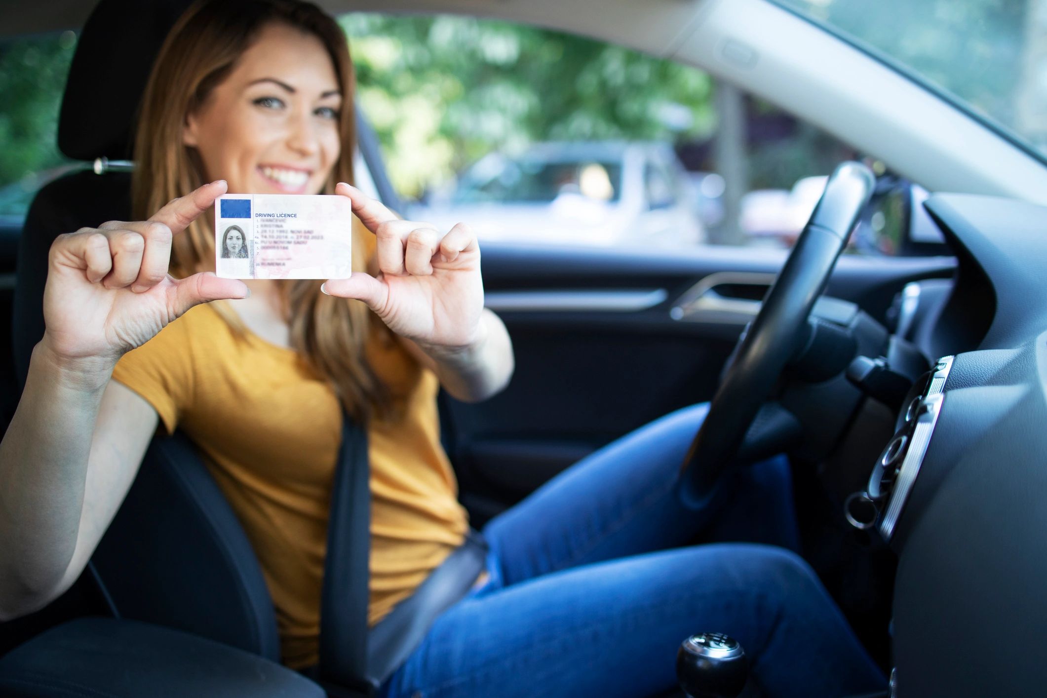 Happy student with driver's license